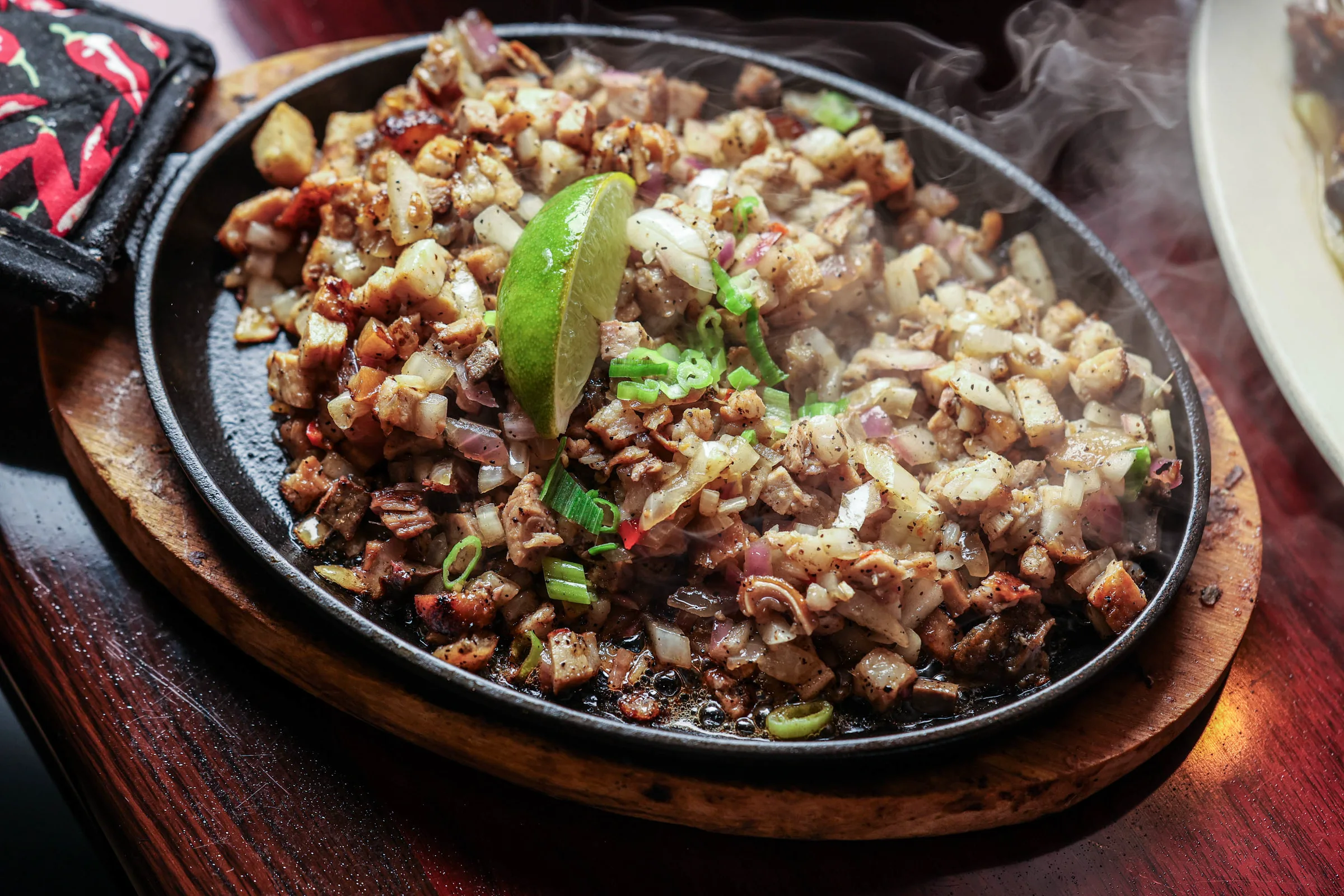 Sizzling pork sisig on cast iron